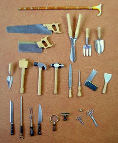 a collection of various tools are laid out on the floor