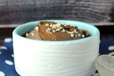 a bowl filled with food sitting on top of a blue and white polka dot table cloth