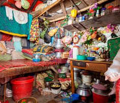 a room filled with lots of pots and pans on top of a wooden table