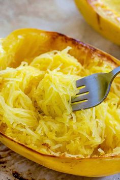 a fork in a spaghetti dish with squash