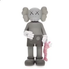 an elephant figurine holding a pink toy