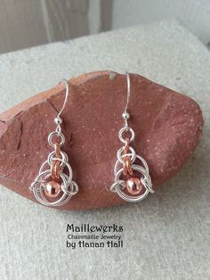 Small Minimalist Geometric Chainmaille Earrings handcrafted with Copper & Bright Silver Plated tarnish-resistant metals and beads.  Lightweight and Petite!  Your Choice of Ear Wires for pierced ears or choose Clip-On for non-pierced ears, in the drop down box above. Measurements: Width: 1/2" wide (12.7 mm) Drop Length:  1"  (25.4 mm) Total Length:  1 1/2" (38.1 mm)   Chainmaille has a fluidity of movement that exudes simple beauty. I handcraft each piece with an Artisan's care and with the love Handmade Medieval Metal Earrings, Medieval Handmade Metal Earrings, Chainmaille Earrings, Biker Art, Chain Maille Jewelry, Simple Beauty, Pierced Ears, Art Jewelry, First Class