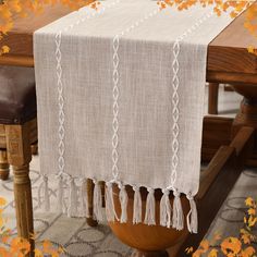 an image of a table runner with tassels on it