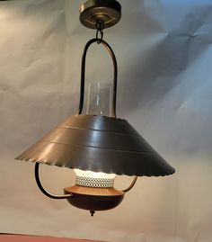 a lamp hanging from the ceiling on a table