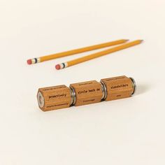 three wooden pencils sitting next to each other