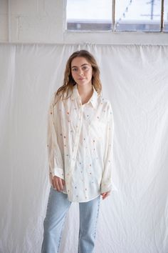 Breezy button-up with embroidered details. - Sizing: Model is 5'8", wearing a size S - Content: 100% Polyester Care: Handwash recommended Imported Casual Button-up Blouse With Floral Embroidery, Embroidered Collared Blouse Relaxed Fit, Embroidered Collared Blouse With Relaxed Fit, Embroidered Relaxed Fit Collared Blouse, Cotton Button-up Blouse With Floral Embroidery, Embroidered Relaxed Fit Shirt For Spring, Multicolor Embroidered Button-up Top, Floral Embroidery Button-up Work Tops, Casual Embroidered Shirt For Daywear