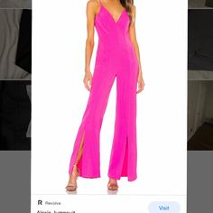 a woman in a bright pink jumpsuit is looking at the camera