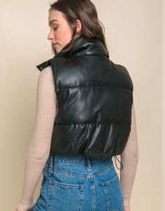 Add a touch of edgy style to your casual outfits with our Faux Leather Puffer Vest. This trendy puffer vest is perfect for layering over your favorite tops. This is a versatile and must-have addition to your casual wardrobe, perfect for staying warm and fashionable during cooler days.PRODUCT SPECIFICATIONS*100% Polyurethane*Brand: Love Tree*Model is wearing a size Small Outfit Mujer, Puffer Vest, Casual Wardrobe, Edgy Fashion, Stay Warm, Must Haves, Puffer, Faux Leather, Casual Outfits