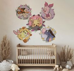 winnie the pooh wall decals in a baby's room with a crib