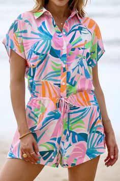 Unleash your inner island goddess with our Tropical Collared Front Button Cover-Up Romper! Perfect for beach days or poolside lounging, this romper features a vibrant tropical print and convenient front buttons. Get ready to bring the vacation vibes wherever you go! Product code: DAA07E4B001DZ Features:  Woven Collared neckline Short sleeves Front buttons Waist tie Material: 100%POLYESTER. Beachy Jumpsuits And Rompers For Vacation, Beachwear Jumpsuits And Rompers With Short Sleeves For Vacation, Printed Beachwear Jumpsuits And Rompers For Beach, Printed Short Sleeve Jumpsuits And Rompers For Beach, Summer Multicolor Tropical Print Jumpsuits And Rompers, Tropical Printed Beach Jumpsuits And Rompers, Tropical Multicolor Jumpsuits And Rompers For Vacation, Tropical Printed Jumpsuits For Vacation, Tropical Printed Jumpsuit For Beach Season