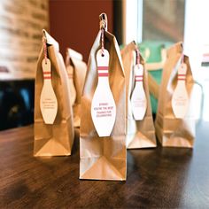 three brown paper bags with bowling pins on them