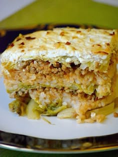 a close up of a plate of food with broccoli and cheese on it