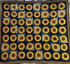 a crocheted blanket with sunflowers on it