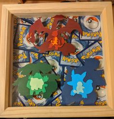 a wooden frame filled with cut outs of pokemon and pikachu characters in different colors