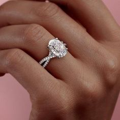 a woman's hand holding an engagement ring