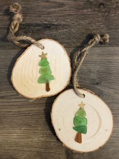 two pieces of wood that have been cut into christmas tree ornaments on top of each other