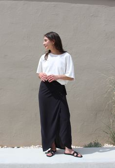 The Bobbie Maxi is a refresh of our coveted Bobbie Skirt - a stunning wrap piece met with an effortless side tie for an adjustable fit and feminine drape that can easily be worn high on the waist or lower on the hip depending on one's mood or occasion. Our sandwashed voile is lightweight and breathable, and serves a nod to a classic vintage hand and will become softer with wear. We envision pairing the Bobbie Maxi with our favorite white buttons ups and a handsome blazer. Made in USA Black Maxi Skirt Styling, Maxi Skirt Styling, Skirt Styling, Maxi Skirt Style, Black Maxi Skirt, White Button Up, Black Maxi, Classic Vintage, Skirt Fashion