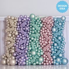 there are many balls and beads on the wall in front of each other, all different colors