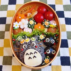 a bowl filled with different types of food on top of a checkered table cloth