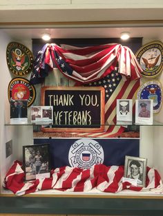 a display case with an american flag and other memorabilia on it's sides, along with the words thank you veterans