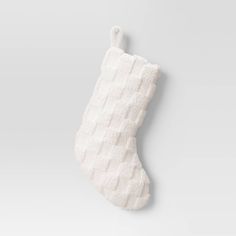 a white christmas stocking hanging on a wall