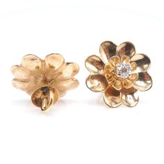 "These charming vintage earrings, in the shape of a daisy, are made of 14K yellow gold and have a diamond prong set in their center. Perfect for \"setting and forgetting,\" these earrings are secured with a screw back, meaning you'll never have to worry about one of them falling out! DETAILS METAL: 14K Yellow Gold DIAMONDS: 2x European Cut diamonds (0.40tcw) WIDTH: 17mm" Gold Flower Diamond Earrings With Prong Setting, Yellow Gold Flower Cluster Earrings For Anniversary, Formal Yellow Gold Flower Earrings, Vintage Yellow Gold Diamond Earrings For Pierced Ears, Vintage Gold Diamond Earrings With Brilliant Cut, Classic Flower Shaped Diamond Earrings For Formal Occasions, Classic Flower Shaped Diamond Earrings For Formal Events, Classic Diamond Flower Earrings For Formal Occasions, Gold Flower-shaped Diamond Earrings With Brilliant Cut