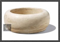 a white stone bowl sitting on top of a table