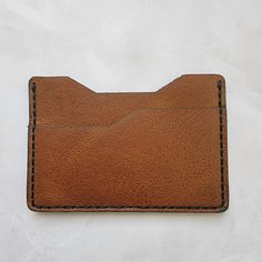 Minimalist Leather Wallet *Slim or minimalist wallet, made from hand-stitched full grain leather cowhide. *Dimensions 2.65 x 3.85 x 0.15 inches. *Please note, Wallet is natural leather and will require break-in/use to become soft and pliable. Natural leather may also have minor variations in color and blemishes. Natural leather is very durable and will last a very long time. Leather Wallets With Card Slots, Hand-stitched Leather Card Holder For Everyday Use, Modern Brown Card Holder For Everyday Carry, Brown Modern Card Holder, Minimalist Leather Bifold Card Holder, Minimalist Leather Wallet With Rfid Blocking, Minimalist Leather Card Holder With Rfid Blocking, Brown Leather Everyday Card Holder, Minimalist Leather Rectangular Wallet