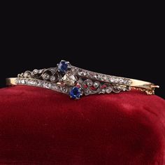 Beautiful Antique Victorian 14K Yellow Gold Rose Cut Diamond and Sapphire Bangle Bracelet. This gorgeous bangle bracelet is crafted in 14k yellow gold and silver top. There are chunky rose cut diamonds all over the bangle with a champagne old euro in the center with a natural sapphire above and below it. It is in great condition and absolutely beautiful. Item #B0062 Metal: 14K Yellow Gold and Silver Top Weight: 18.6 Grams Size: 2 1/2 inches diameter (east to west) inside the bangle Center Diamon Sapphire Bangle, Diamond Cuff Bracelet, Sapphire Wedding Band, Gold Link Chain, Sapphire Wedding, Silver Tops, Antique Engagement, Antique Engagement Rings, Fine Jewelry Bracelets