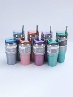 there are many different colored cups with straws in them