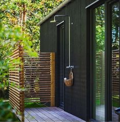 an outdoor shower in the middle of a wooden deck