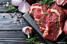 raw meat with herbs and garlic on a cutting board