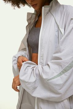 Fend off the breeze and feel like a dream while doing it. The Stand Collar Jacket is a lightweight little number that goes from street to studio and back again. With full-zip and hood, curved hem, and pockets at both sides. Wear over just about anything. Stand Collar Jacket, Stand Collar Jackets, Athleisure Women, The Stand, Active Jacket, Oversize Fashion, Collar Jacket, Sweater Coats, Bra Tops