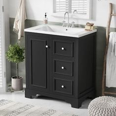 a white sink sitting under a bathroom mirror