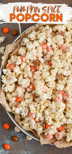 pumpkin spice popcorn in a bowl with candy on the side and text overlay that reads pumpkin spice popcorn