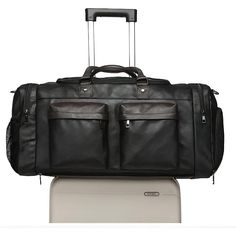 Introducing the Elegant Weekender Travel Duffle Bag, a perfect companion for your travel and gym needs. This stylish bag features multiple compartments, including a dedicated shoe pocket, ensuring your belongings are organized and easily accessible. Features: Material: Made from high-quality faux leather, offering durability and a sophisticated look. Design: Features a sleek design with multiple front zippered pockets, a shoe compartment, and a detachable strap for versatile carrying options. Sp Faux Leather Travel Bag With Luggage Sleeve, Leather Travel Bag With Pockets, Functional Leather Duffle Bag, Large Capacity Leather Travel Bag, Large Capacity Leather Travel Accessories, Functional Leather Travel Accessories With Large Capacity, Large Capacity Leather Luggage, Large Capacity Leather Luggage, Functional Style, Practical Large Capacity Leather Travel Bag