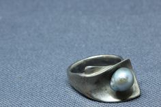 "Sterling Silver Gray Pearl Ring. Vintage Modernist sterling silver and gray pearl ring. Ring is fully hallmarked and will arrive gift boxed. * HALLMARKS Sterling and makers mark which I couldn't make out. * WEIGHT 7.91 Grams * Size 6 1/2, ring can be resized by any good jeweler. Face of ring measures 1/2\" at widest part. * CONDITION In very good condition. Please use pictures as part of item's description. * MATERIALS Sterling Silver, gray pearl" Handmade Silver Pearl Ring For Formal Occasions, Modern Silver Pearl Ring As Gift, Modern Silver Pearl Ring For Gifting, Pearl Ring Vintage, Mens Initial Ring, Pearl Jewelry Ring, Ancient Coin Jewelry, Fine Pearl Jewelry, Healing Crystal Ring