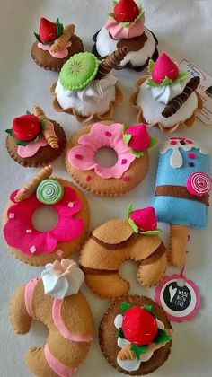 a table topped with lots of different types of donuts and cupcakes on top of each other