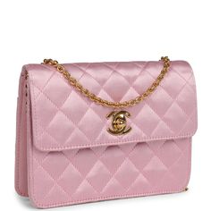 This Vintage mini flap bag is in Pink satin with gold hardware, featuring a single straight front flap with signature CC logo turnlock, a rear slip pocket, and a gold chain link shoulder/crossbody strap.The interior is lined in gold leather and includes one slip pocket on the back wall. Collection: 2-series (1991-1994) Origin: FranceCondition: Vintage; Excellent - This bag retains its shape and structure. There are some signs of wear to the exterior, including dirt marks, light staining, and mod Chanel Mini Flap Bag, Chanel Mini, Cc Logo, Vuitton Bag, Vintage Chanel, Pink Satin, Gold Leather, Flap Bag, Pink Bag