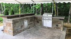 an outdoor kitchen that is built into the ground