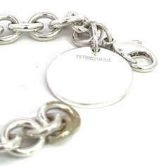 Authentic Tiffany & Co Estate Bracelet 6.75" Sterling Silver TIF526This elegant Authentic Tiffany & Co bracelet is made of sterling silver and has a weight of 33.7 grams.TRUSTED SELLER SINCE 2002PLEASE SEE OUR HUNDREDS OF POSITIVE FEEDBACKS FROM OUR CLIENTS!!FREE SHIPPING!!DETAILSStyle: BraceletLength: 6.75 InchesWeight: 33.7 GramsMetal: Sterling SilverWe try to present our Tiffany estate items as best as possible and most have been newly polished some of the Tiffany items may have a natural pat Sterling Silver Bracelet With Polished Finish, Classic White Gold Charm Bracelet With Polished Finish, Timeless Engraved Sterling Silver Bracelet, Classic Silver Charm Bracelet With Polished Finish, Luxury White Gold Sterling Silver Charm Bracelet, Luxury Silver Charm Bracelet With Polished Finish, Silver Luxury Charm Bracelet With Polished Finish, Classic Engraved Sterling Silver Charm Bracelet, Luxury White Gold Bracelets With Silver-tone Logo