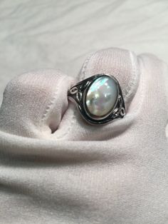 Lovely polished 925 sterling silver with a huge white Mother Of Pearl set in very detailed vintage filigree Size 6, 7, 8,9 or 10 We can size these with an additional $10- $20 fee for the jeweler All rings are shipped in a nice gift box. Check out our over a THOUSAND great reviews Engraving is $4 per letter and is not always perfect depending on the piece. It can take a few days if the jeweler is busy. This is payable to Paypal Judithsltd@gmail.com Heirloom Silver Oval Pearl Ring, Vintage White Oval Cabochon Ring, Handmade Vintage Oval Pearl Ring, Vintage Silver Oval Pearl Ring, Vintage Oval Sterling Silver Pearl Ring, Vintage Oval Pearl Ring In Sterling Silver, Antique White Pearl Ring Hallmarked, Handmade Vintage Pearl Ring In Sterling Silver, Handmade Vintage Sterling Silver Pearl Ring