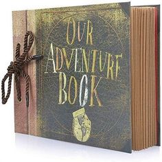 an open book with the words our adventure book written on it and a rope attached to it