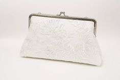 "For brides-to-be, this is a delightful accessory to complement any bridal occasion look. Carry as a hand clutch or attach the handle chain. Top clasp closure. Soft and romantic! This white delicate made from white embriodered lace overlaid on white, a little dazzling with clear sequins, lining in beautiful blue silk or can be custom color (choose from rose chart), secured closure with brass purse frame and comes with handle chians. Versatile to compliment most styles and big enough to carry all Elegant Clutch For Wedding, Feminine White Evening Bag For Wedding, White Feminine Evening Bag For Wedding, Elegant White Clutch For Formal Occasions, Chic Rectangular Clutch For Wedding, Elegant White Formal Clutch, Elegant Handheld Evening Bag For Wedding, Elegant Formal Bridal Accessories, Elegant White Evening Bag For Wedding