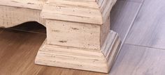 a wooden bench sitting on top of a hard wood floor