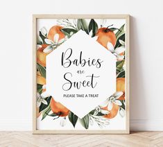 a framed sign that says babies are sweet please take a treat with oranges and white flowers