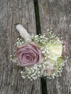 a bridal bouquet sitting on top of a wooden bench