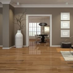 a living room filled with lots of furniture next to a white vase on top of a hard wood floor