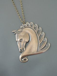 Vintage Jewelry - Art Deco Necklace - Vintage Necklace - Horse Necklace - Horse Jewelry - Statement Necklace - Chloes Vintage jewelry  This is such an exquisite vintage necklace! A large brass Art Decod esign horse hangs from a pretty vintage brass ladder chain. So very bold and feminine. Chloe Metal Horse Design Jewelry Gift, Vintage Silver Jewelry With Horse Design, Vintage Art Deco Necklace, Horse Necklace, Vintage Jewelry Art, Brass Art, Horse Jewelry, Art Deco Pendant, Art Deco Necklace