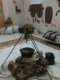 a room with many items on the floor and decorations hanging from the wall behind them